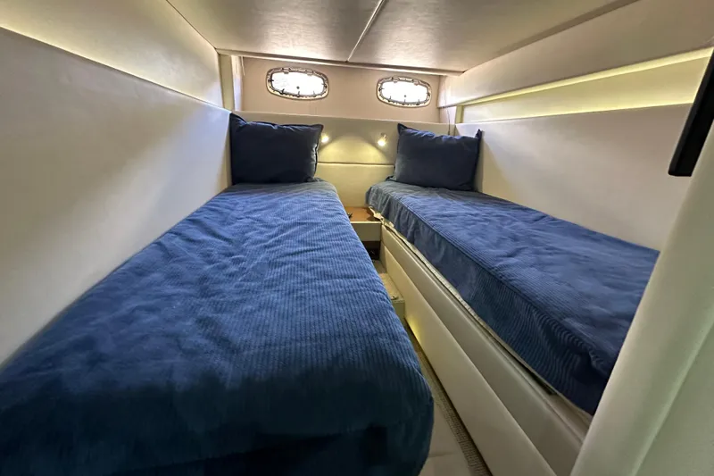  Yacht Photos Pics Twin beds in a 2012 Sea Ray 470 Sundancer yacht cabin with blue bedding.