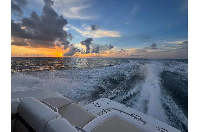  Yacht Photos Pics 2012 Sea Ray 470 Sundancer cruising at sunset, leaving a wake on the ocean.