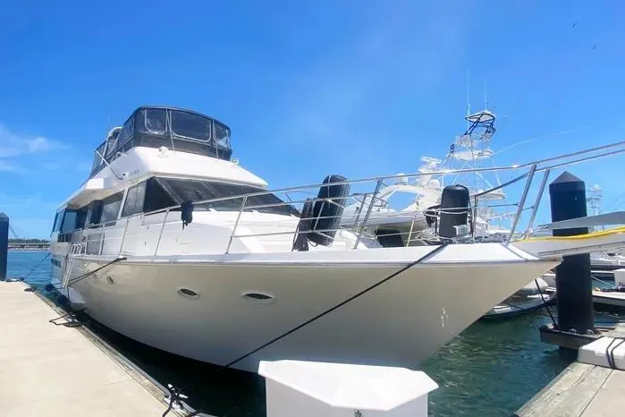Sea Sharp Yacht Photos Pics 1990 Viking Motor Yacht docked under clear blue sky.