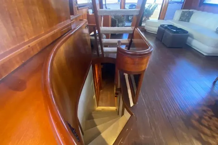 Sea Sharp Yacht Photos Pics Interior of a 1990 Viking Motor Yacht with wooden stairs and elegant seating area.