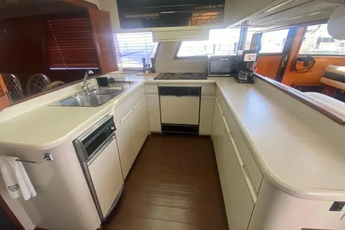 Sea Sharp Yacht Photos Pics 1990 Viking Motor Yacht kitchen with modern appliances and sleek countertops.
