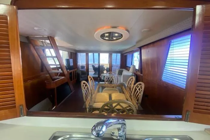 Sea Sharp Yacht Photos Pics Interior of a 1990 Viking Motor Yacht featuring a dining area with wooden accents.