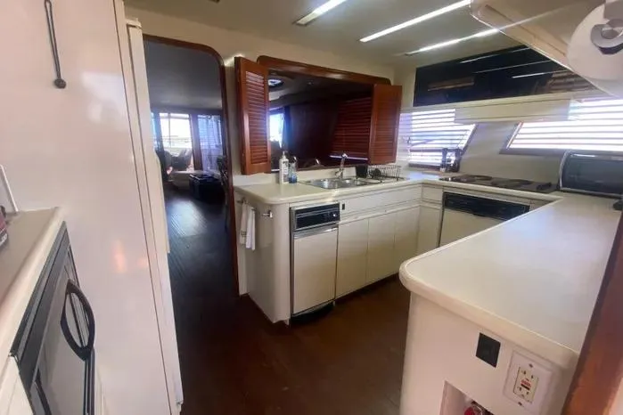 Sea Sharp Yacht Photos Pics 1990 Viking Motor Yacht kitchen with modern appliances and wood accents.