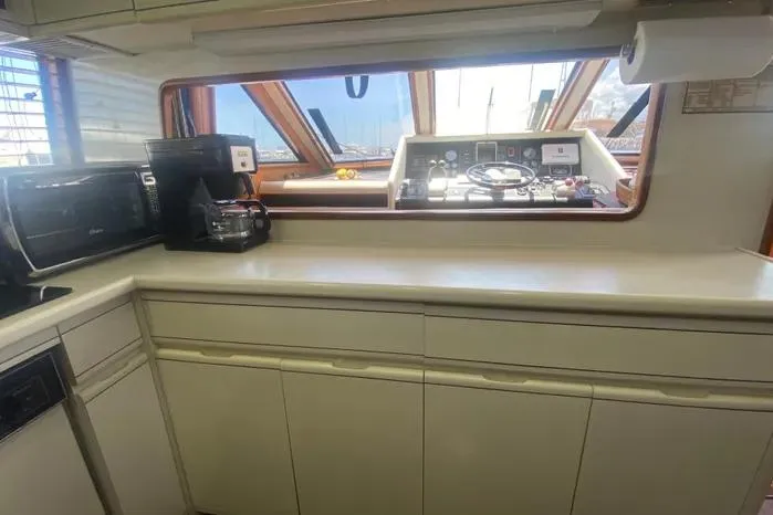 Sea Sharp Yacht Photos Pics Interior of a 1990 Viking Motor Yacht with kitchen and helm view.