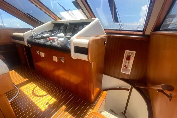 Sea Sharp Yacht Photos Pics Interior helm of 1990 Viking Motor Yacht with wooden finish and navigation controls.