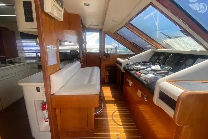Sea Sharp Yacht Photos Pics Interior of 1990 Viking Motor Yacht with wooden accents and navigation controls.