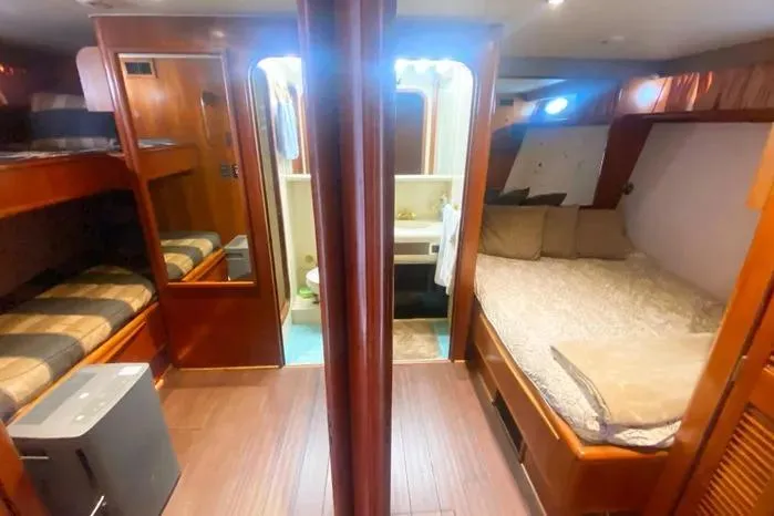 Sea Sharp Yacht Photos Pics 1990 Viking Motor Yacht interior with cozy sleeping quarters and wooden finishes.