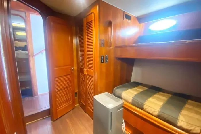 Sea Sharp Yacht Photos Pics Cozy cabin interior of 1990 Viking Motor Yacht with wooden finishes and bunk bed.