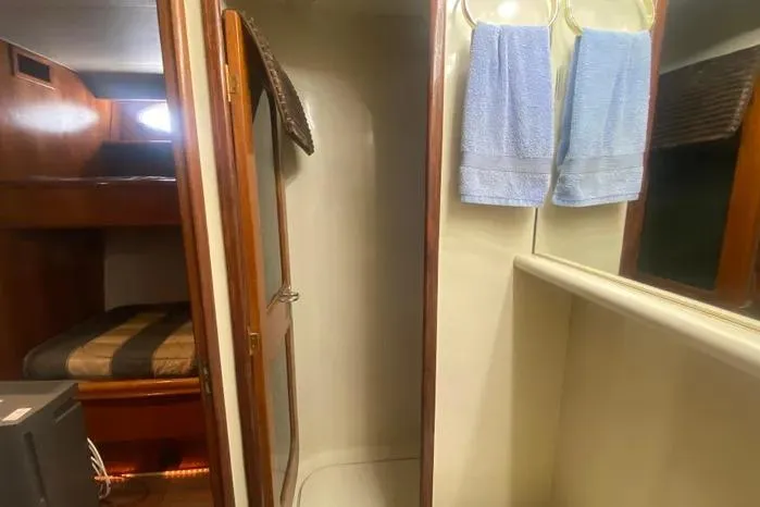 Sea Sharp Yacht Photos Pics Interior of 1990 Viking Motor Yacht with shower, towels, and cozy sleeping area.