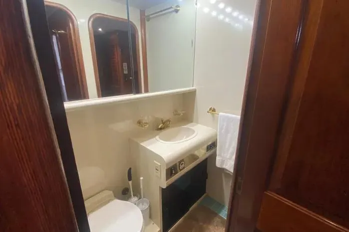 Sea Sharp Yacht Photos Pics Bathroom interior of a 1990 Viking Motor Yacht with sink and mirror.