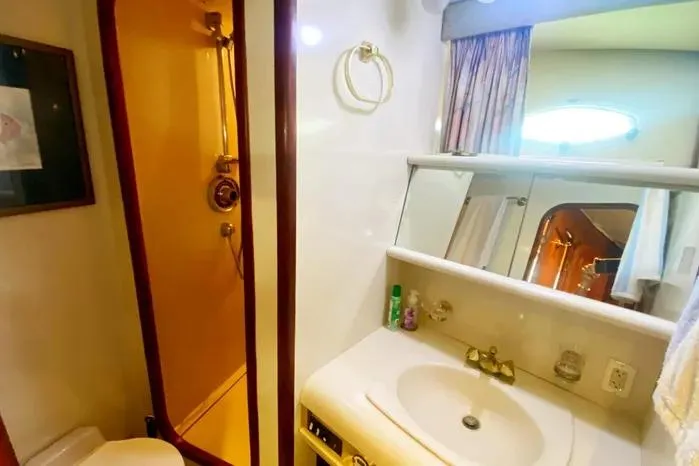 Sea Sharp Yacht Photos Pics Bathroom interior of a 1990 Viking Motor Yacht with shower and sink.
