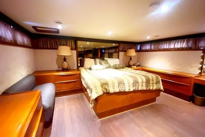 Sea Sharp Yacht Photos Pics Luxurious bedroom interior of a 1990 Viking Motor Yacht with elegant wood furnishings.