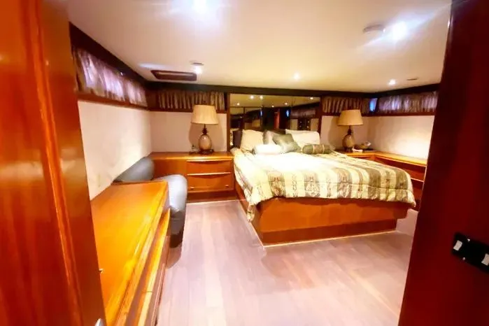 Sea Sharp Yacht Photos Pics Luxurious 1990 Viking Motor Yacht bedroom with elegant wood furnishings and ambient lighting.