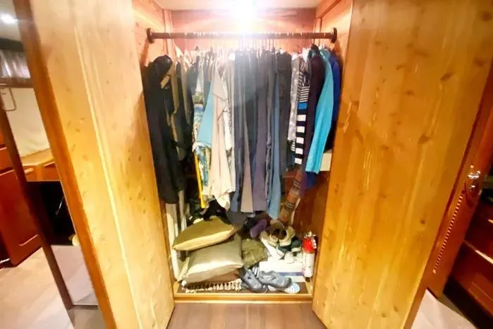 Sea Sharp Yacht Photos Pics Closet inside 1990 Viking Motor Yacht with clothes and accessories neatly arranged.