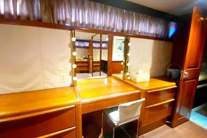 Sea Sharp Yacht Photos Pics Vanity area in a 1990 Viking Motor Yacht with wooden cabinetry and mirror.