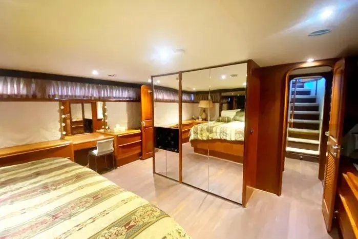 Sea Sharp Yacht Photos Pics Luxurious 1990 Viking Motor Yacht bedroom with mirrored closet and elegant wood finishes.