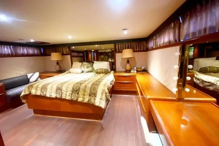 Sea Sharp Yacht Photos Pics Luxurious 1990 Viking Motor Yacht bedroom with elegant wood furnishings and ambient lighting.