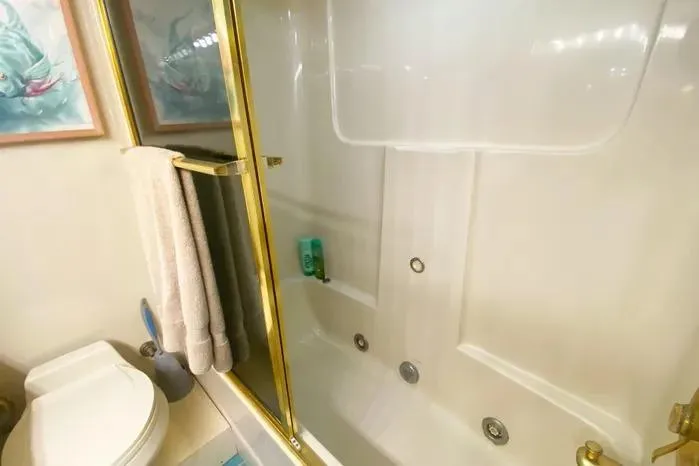 Sea Sharp Yacht Photos Pics Bathroom interior of 1990 Viking Motor Yacht with shower and toilet.