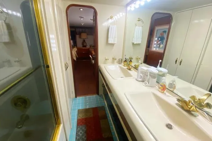 Sea Sharp Yacht Photos Pics Luxurious bathroom in a 1990 Viking Motor Yacht with dual sinks and elegant fixtures.