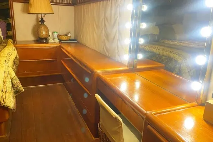 Sea Sharp Yacht Photos Pics Luxurious 1990 Viking motor yacht interior with wooden vanity and illuminated mirror.