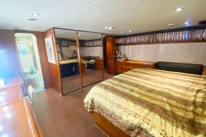 Sea Sharp Yacht Photos Pics Luxurious 1990 Viking Motor Yacht bedroom with elegant wood finishes and spacious layout.