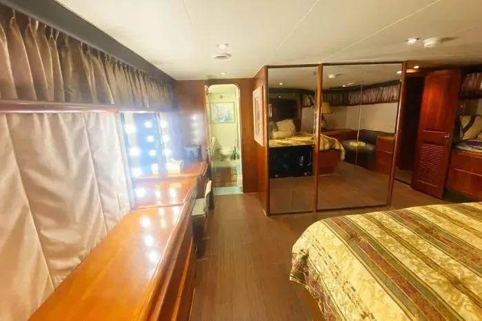 Sea Sharp Yacht Photos Pics Luxurious 1990 Viking Motor Yacht interior with elegant wood finishes and cozy bedroom.