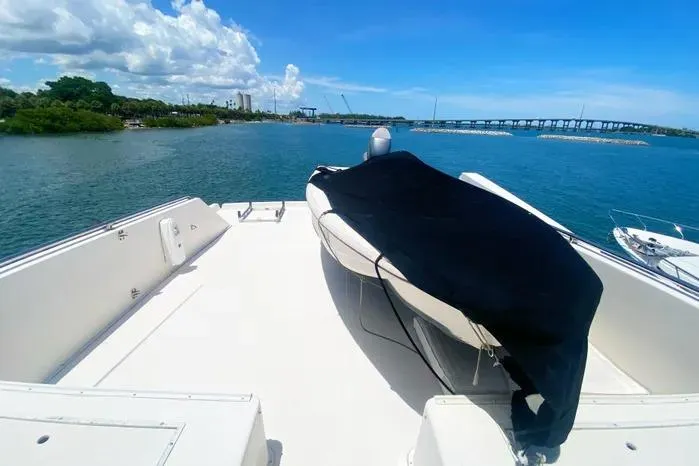 Sea Sharp Yacht Photos Pics 1990 Viking Motor Yacht deck with covered equipment, overlooking scenic waterway and bridge.