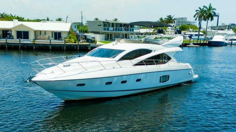 Currency Yacht Photos Pics 2009 Sunseeker 60 Manhattan yacht cruising on a sunny waterfront.
