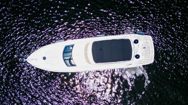 Currency Yacht Photos Pics Aerial view of 2009 Sunseeker 60 Manhattan yacht cruising on water.