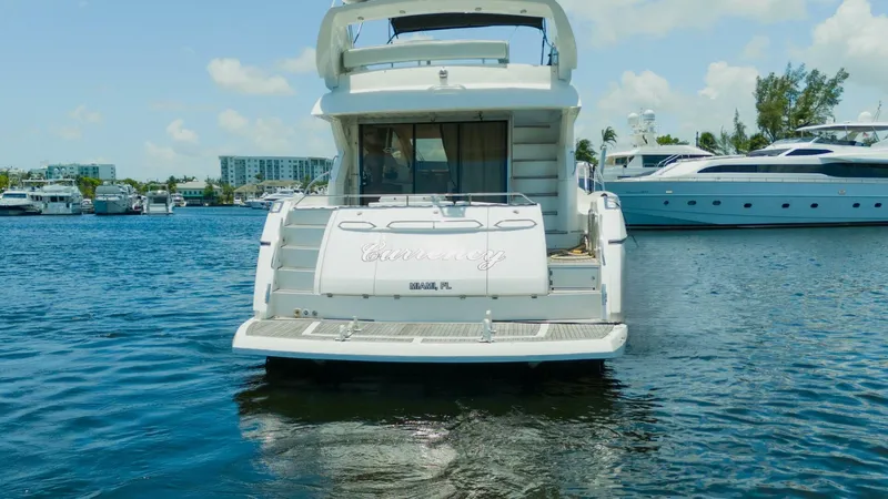 Currency Yacht Photos Pics 2009 Sunseeker 60 Manhattan yacht docked in a marina, rear view.
