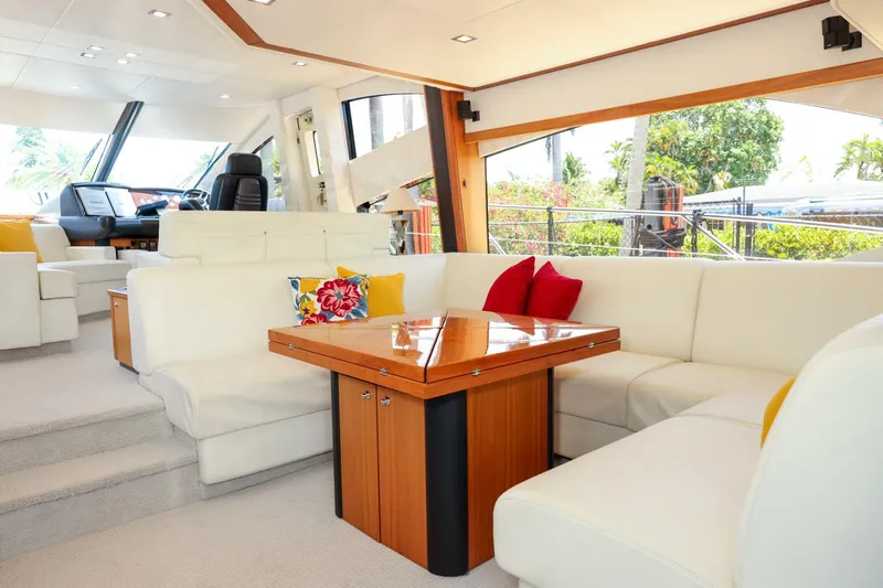 Currency Yacht Photos Pics Luxurious interior of 2009 Sunseeker 60 Manhattan yacht with elegant seating and vibrant cushions.