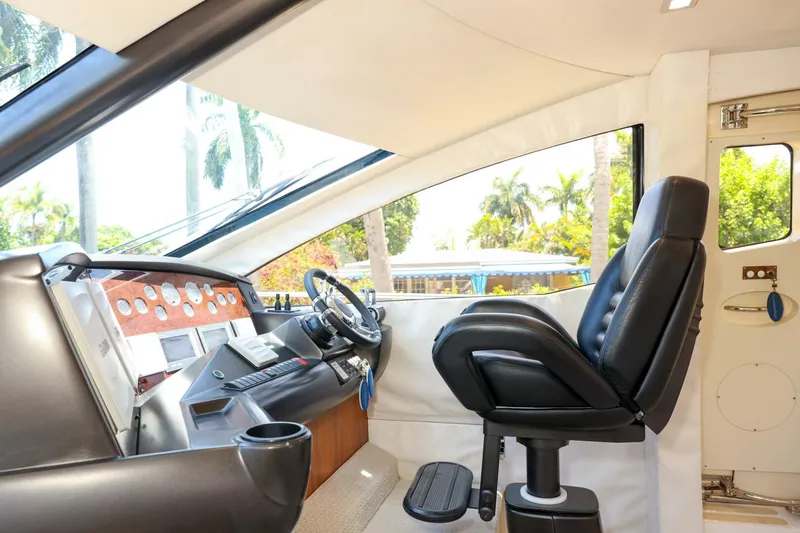 Currency Yacht Photos Pics Interior helm of 2009 Sunseeker 60 Manhattan yacht with modern controls and seating.
