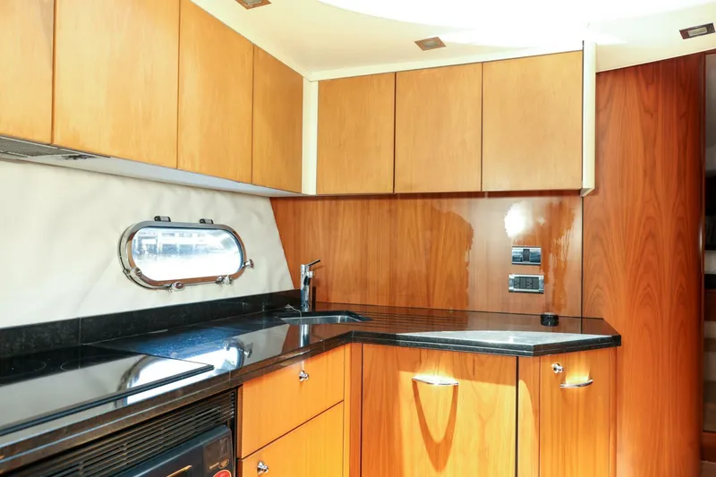 Currency Yacht Photos Pics Luxurious kitchen interior of 2009 Sunseeker 60 Manhattan yacht with wood cabinetry.