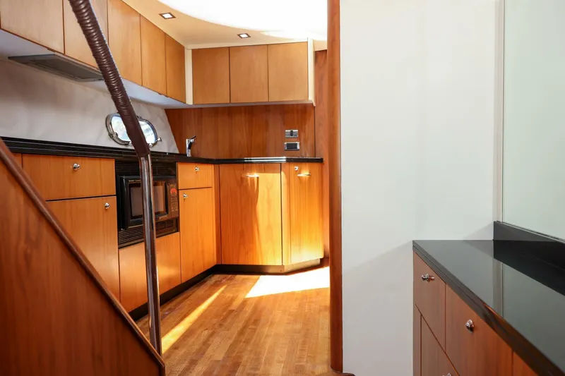 Currency Yacht Photos Pics Luxurious wooden kitchen interior on a 2009 Sunseeker 60 Manhattan yacht.