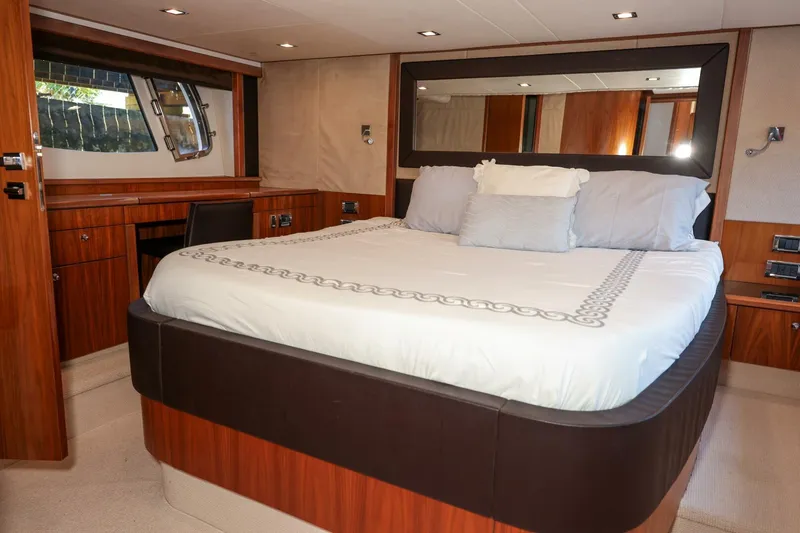 Currency Yacht Photos Pics Luxurious bedroom interior of 2009 Sunseeker 60 Manhattan yacht with elegant wood finishes.