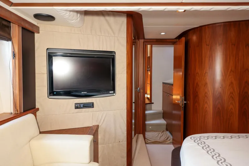 Currency Yacht Photos Pics Interior of 2009 Sunseeker 60 Manhattan yacht with TV and luxurious wood paneling.