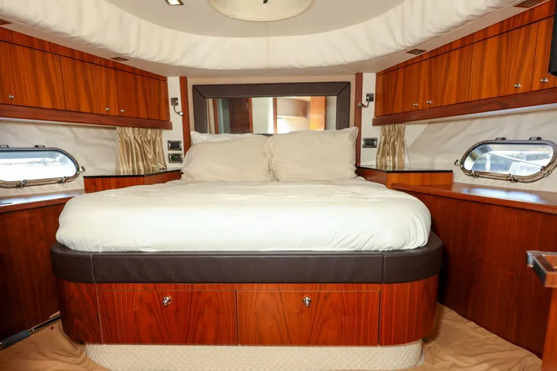 Currency Yacht Photos Pics Luxurious cabin interior of 2009 Sunseeker 60 Manhattan yacht with elegant wood finish.