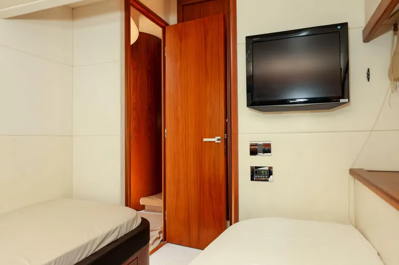 Currency Yacht Photos Pics Interior cabin of 2009 Sunseeker 60 Manhattan yacht with TV and wooden door.