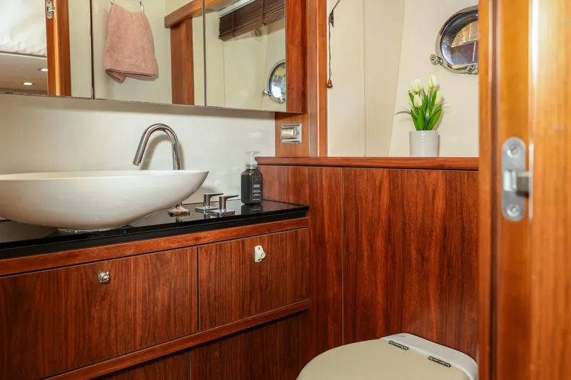 Currency Yacht Photos Pics Luxurious bathroom in 2009 Sunseeker 60 Manhattan yacht with modern sink and wood finish.