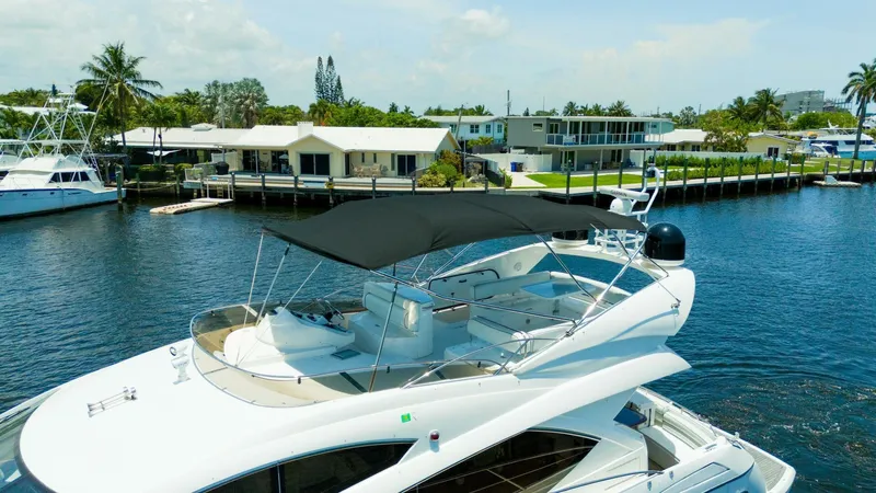 Currency Yacht Photos Pics 2009 Sunseeker 60 Manhattan yacht docked in a scenic waterfront setting.