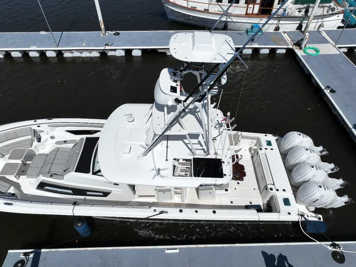 Happy Hour Yacht Photos Pics 2022 Pursuit s428 boat docked with triple outboard engines, aerial view.