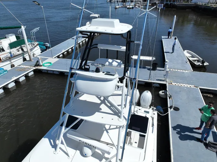 Happy Hour Yacht Photos Pics 2022 Pursuit s428 boat docked at marina with elevated tower view.