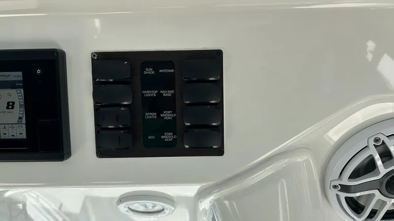 Happy Hour Yacht Photos Pics Control panel and speaker on a 2022 Pursuit s428 boat dashboard.