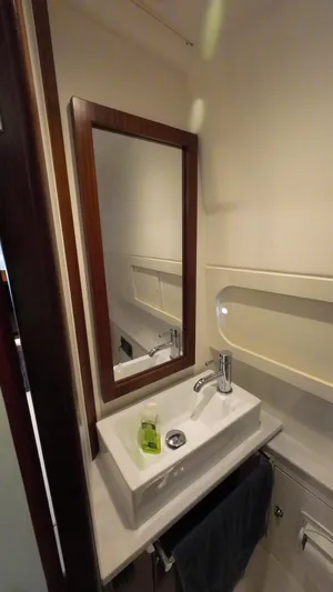 Happy Hour Yacht Photos Pics Compact bathroom in 2022 Pursuit s428 boat with modern sink and mirror.
