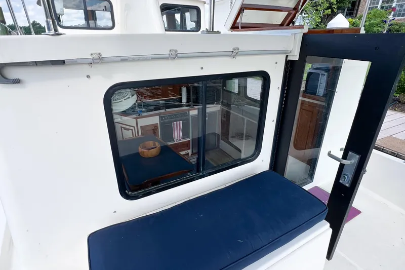 Mirage Yacht Photos Pics Nordic 32 boat interior view through window, showcasing kitchen area, 1999 model.