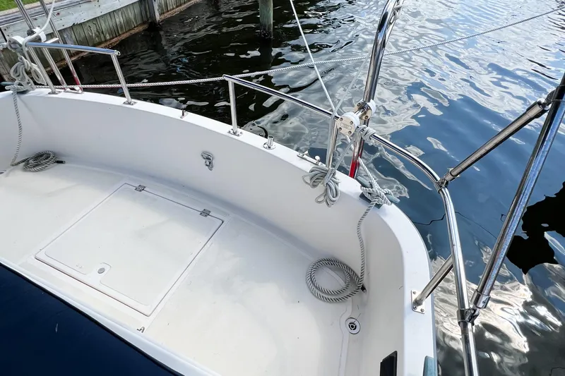 Mirage Yacht Photos Pics Nordic 32 sailboat deck, 1999 model, with ropes and railing by the water.