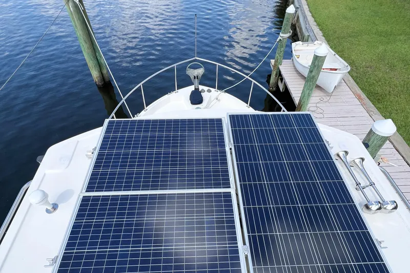 Mirage Yacht Photos Pics Nordic 32 boat with solar panels docked by the water, 1999 model.