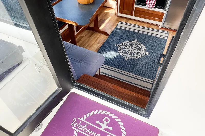 Mirage Yacht Photos Pics Interior view of a 1999 Nordic 32 boat with nautical-themed decor.