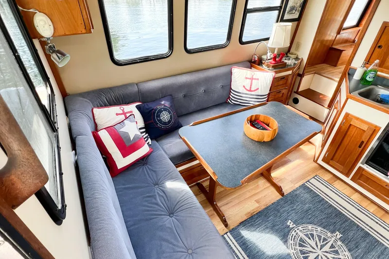 Mirage Yacht Photos Pics Cozy Nordic 32 boat interior with nautical-themed cushions and wooden furnishings, 1999 model.