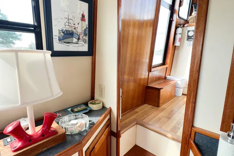 Mirage Yacht Photos Pics Interior of a 1999 Nordic 32 boat with wooden finishes and nautical decor.